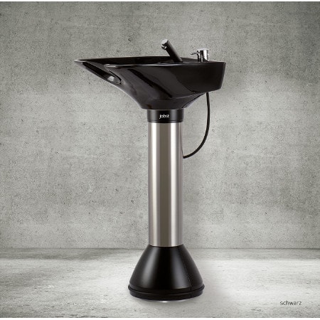 Moderne, schwarze Standwaschsäule mit Edelstahlfuß vor grauer Wand, ideal für Salons und Spa-Einrichtungen.